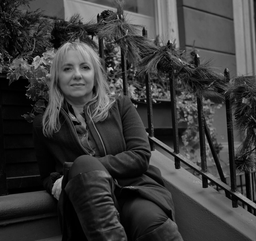 Life Target's Catrine Bo’ Griffith sitting on the steps outside a walkup apartment building in NYC.